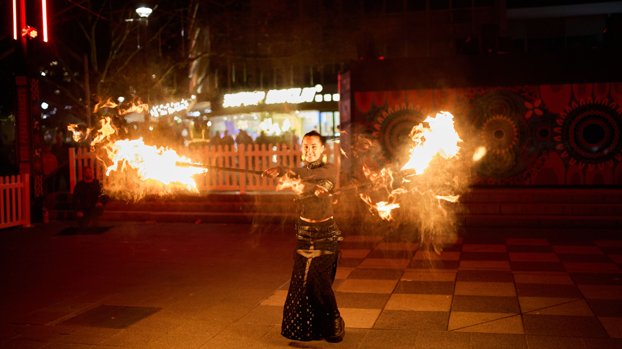 A fire performer in Garema Place.