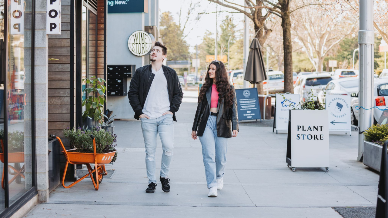 A man and woman walk along Lonsdale Street 