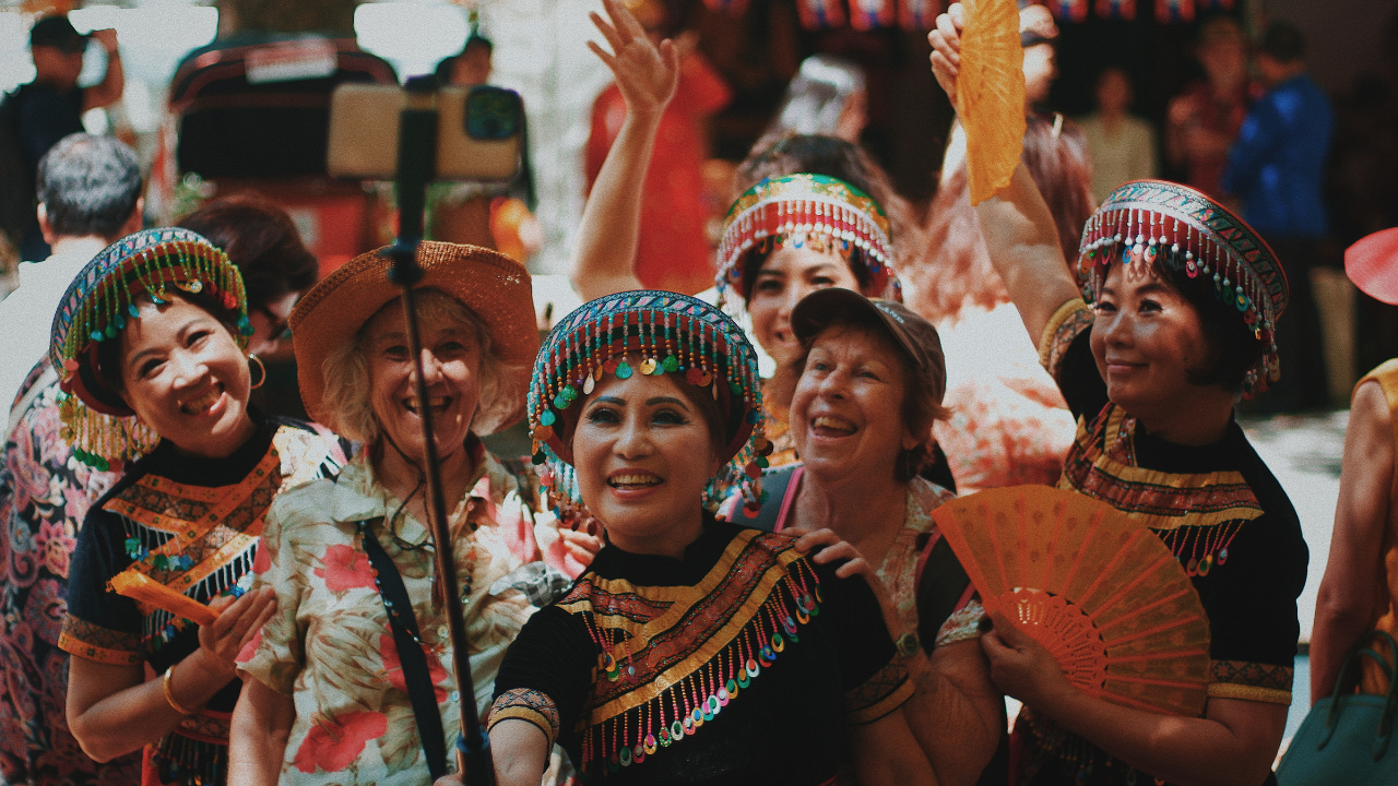 Visitors to the National Multicultural Festival enjoying a selfie with performers