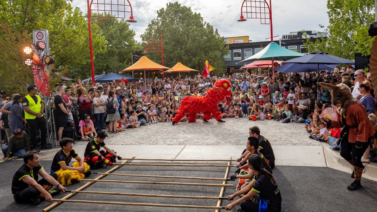 A lion dancer performs for crowds in Dickson.