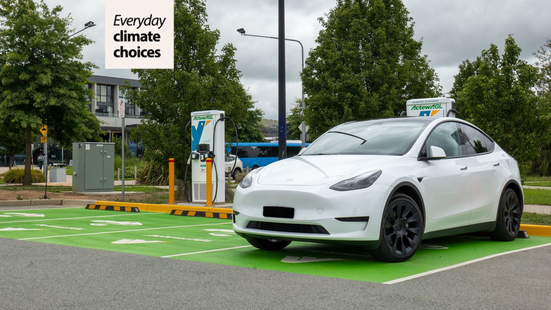 An electric vehicle is parked and plugged into an EV charging bay. 