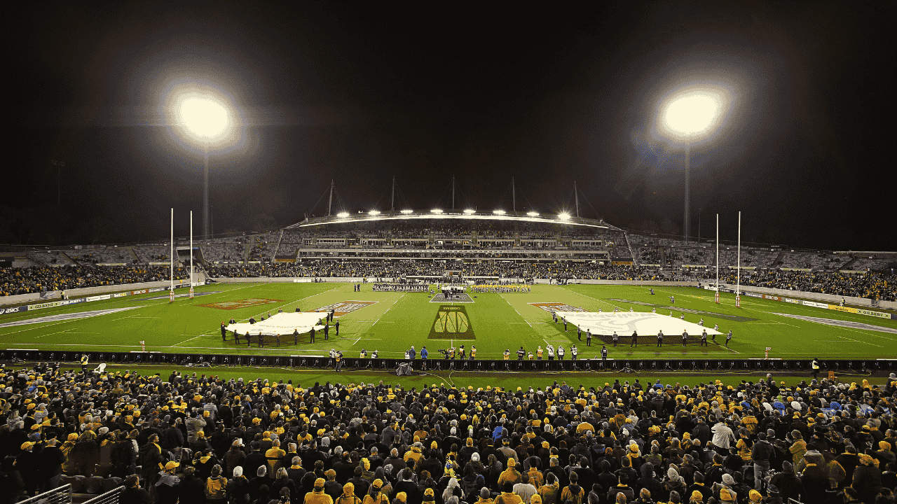 A large sports stadium at night time.