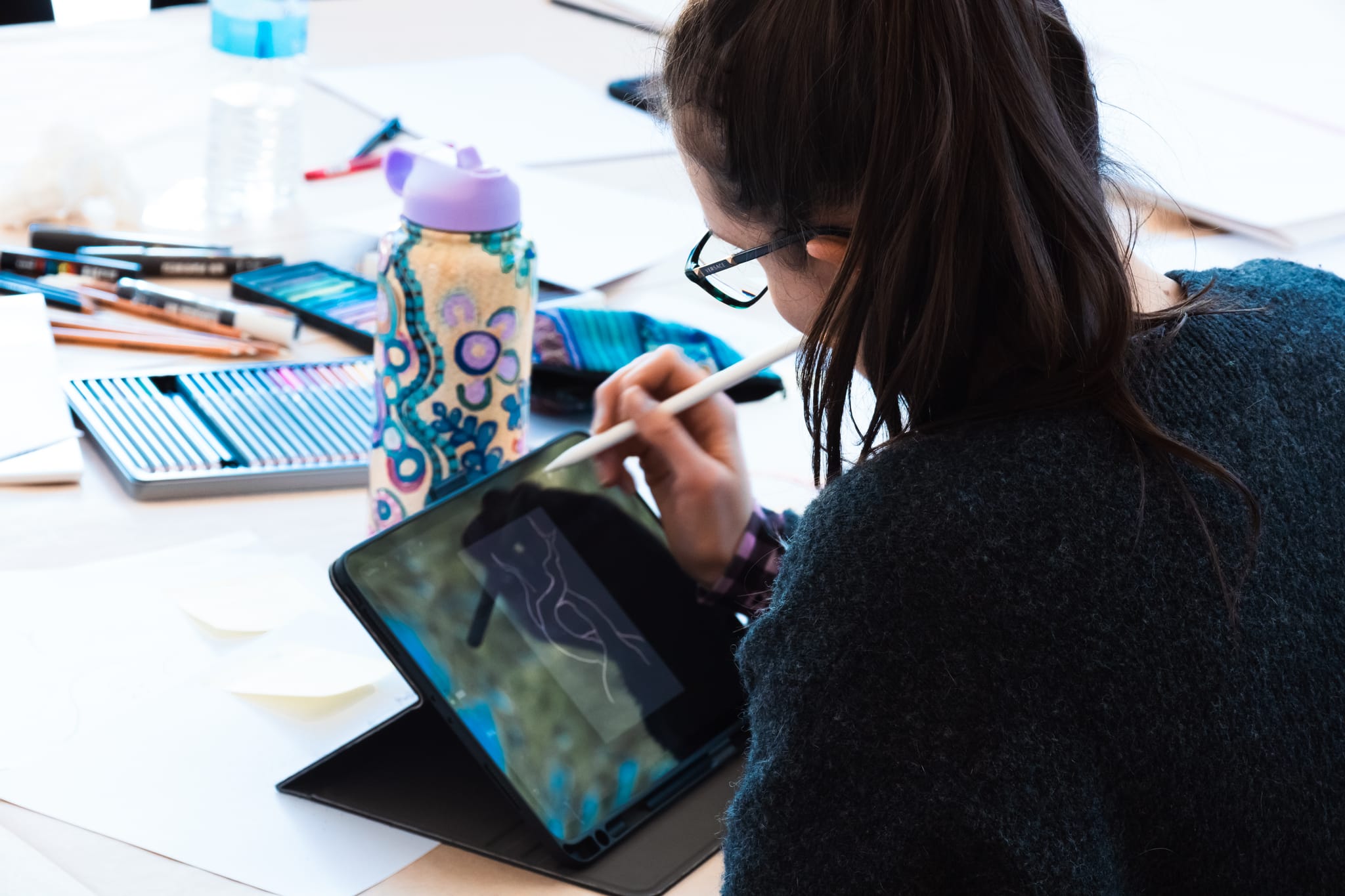 Ngunnawal artist working on a design during the design workshop. 