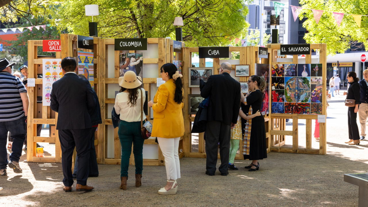 People looking at the open-air art gallery showcasing modern and traditional Latin American art