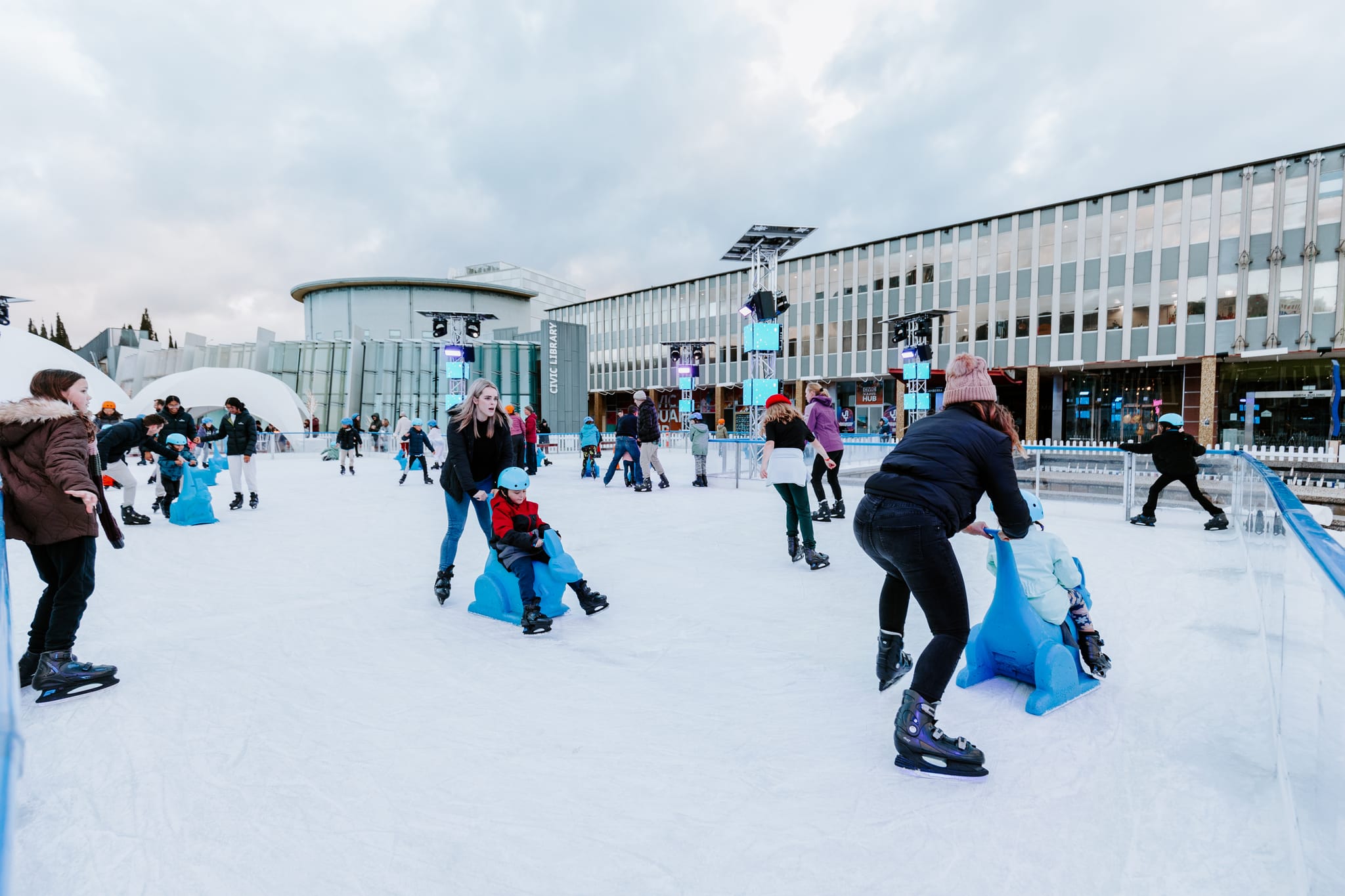 A cvrowd of people ice skating in Civic Square. 