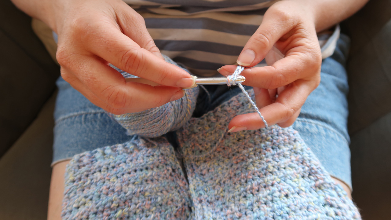 Close up of a woman's hands knitting.