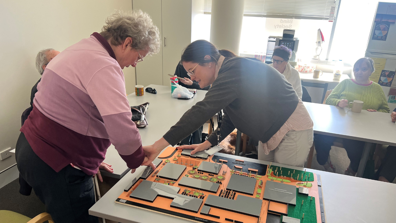 The Authority&rsquo;s Project Manager Sophie Davis (right) guiding a Canberra Blind Society member through the tactile map.