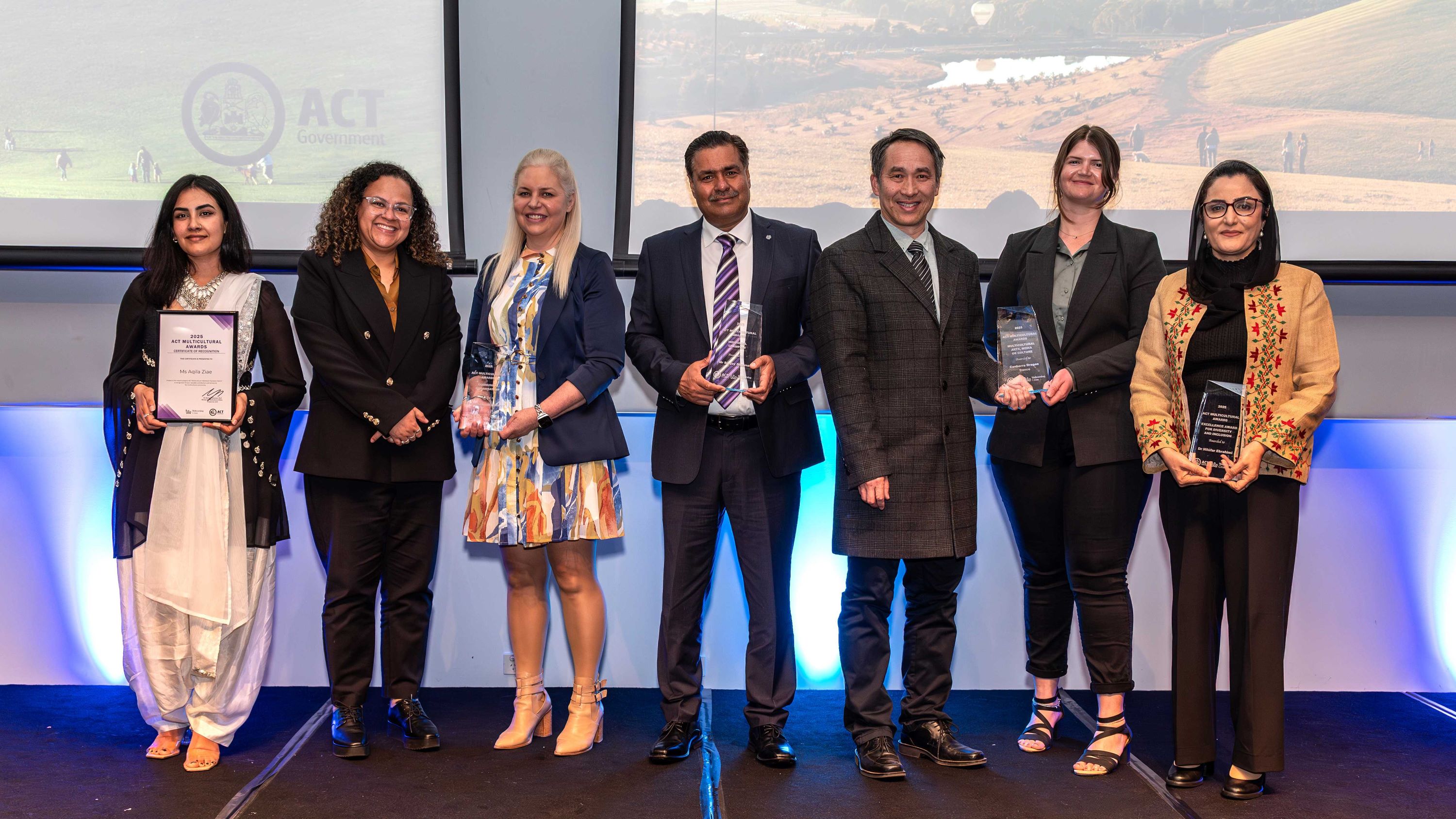Seven people display their awards on award night