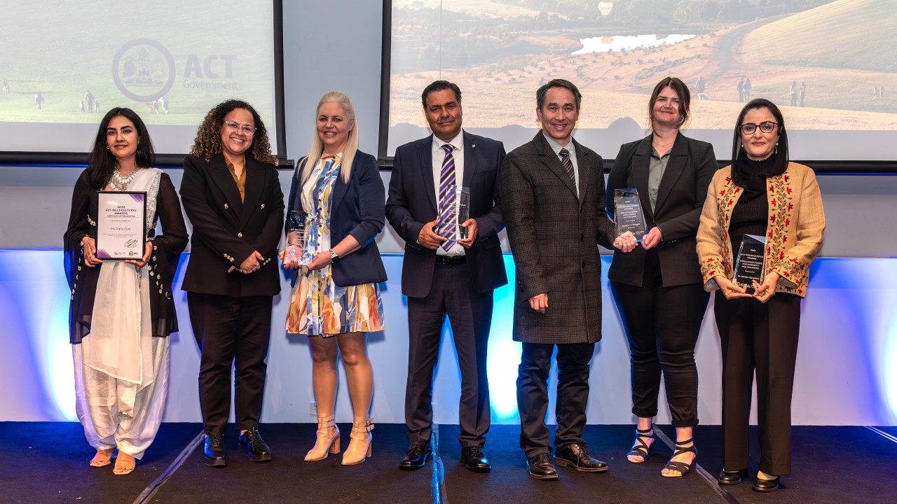 The 2025 ACT Multicultural Award winners standing together with their awards