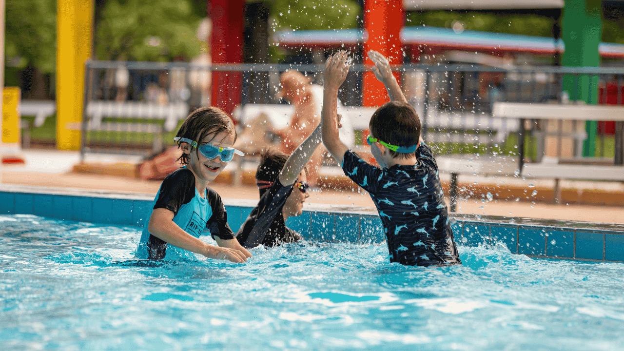 Kids play in a pool.