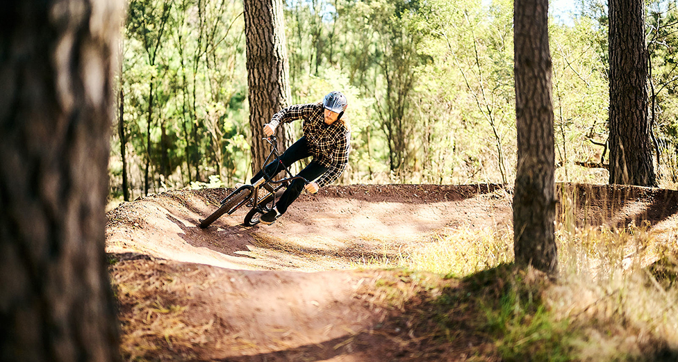 A man rides a BMX bike on a dirt track