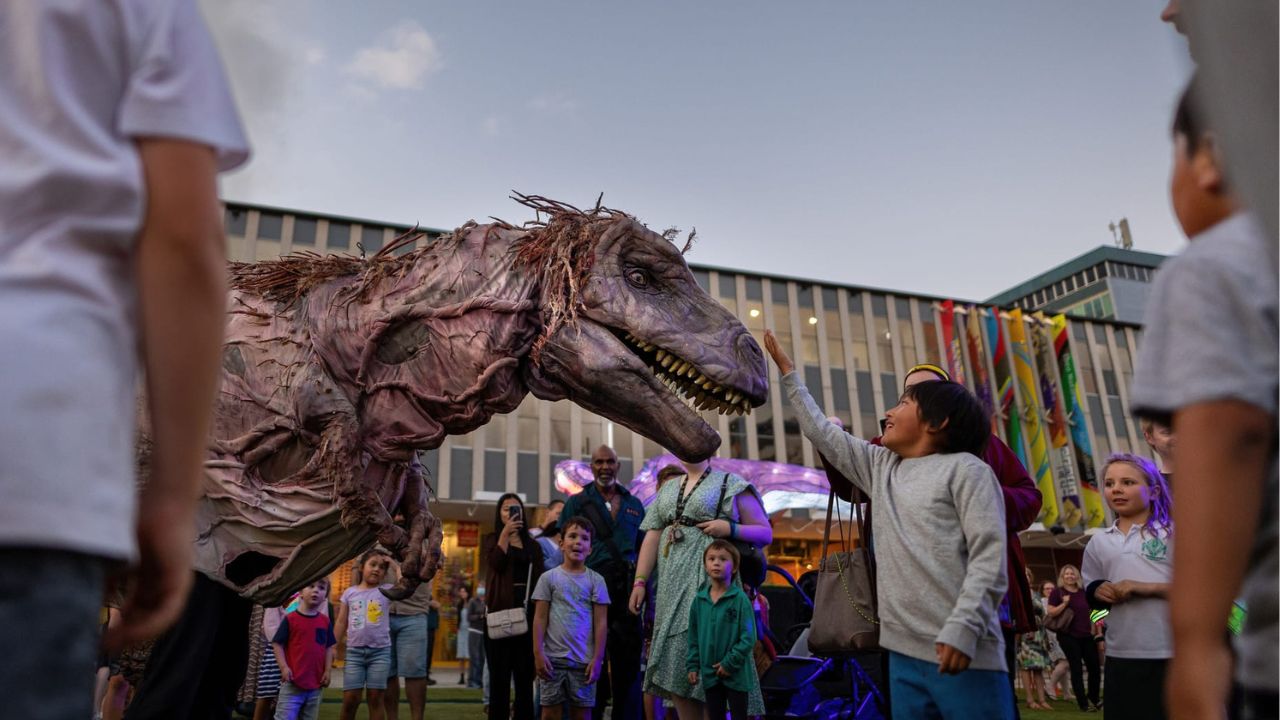 Dinosaur puppet performance entertains children at Enlighten in Civic Square. 