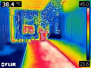 A thermal image of a laneway at Dickson shops, showing the radiant heat from the shade struture and pavement, as well as a cooler shaded area that benefits from airflow.