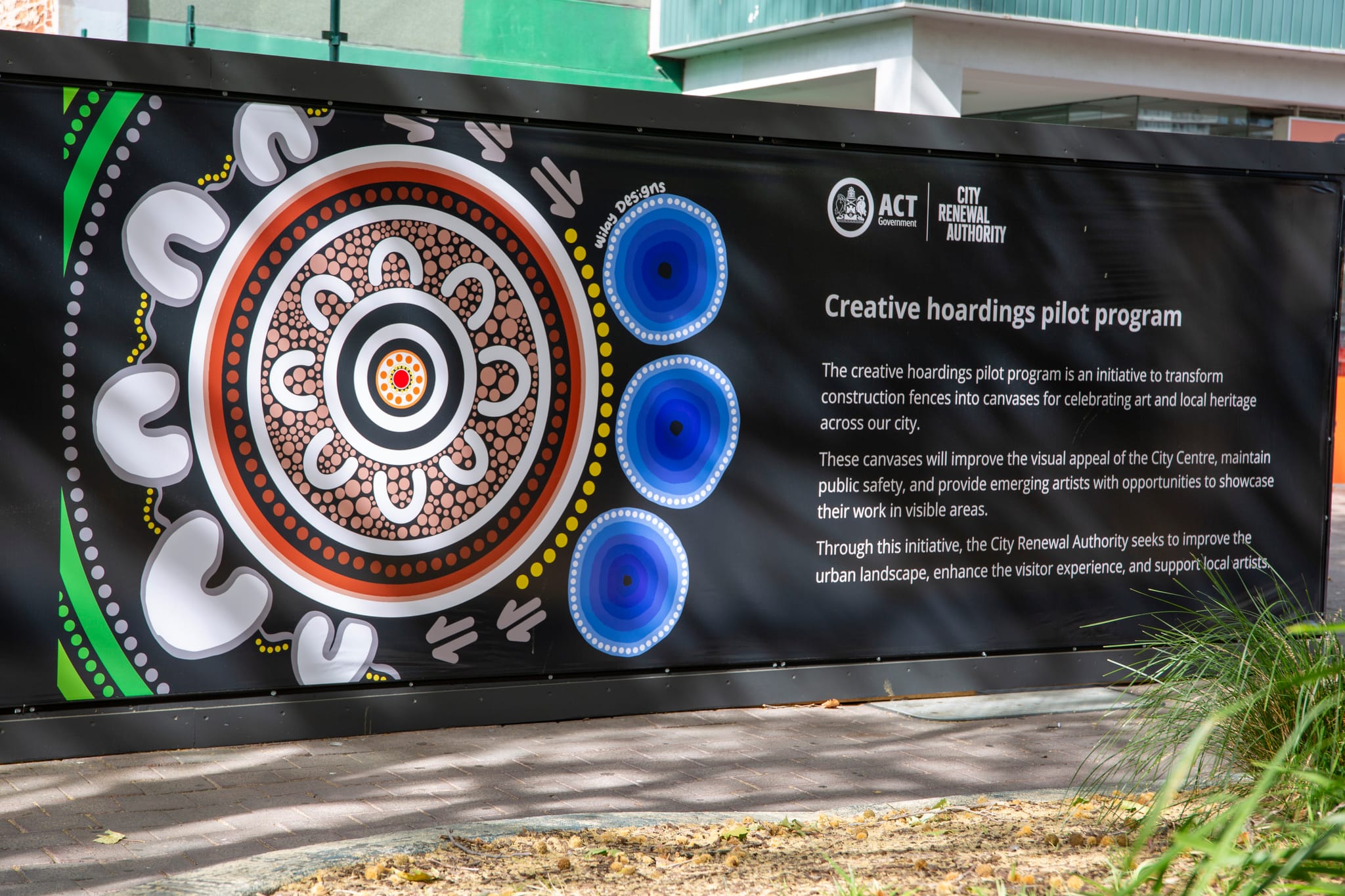 Artwork displayed next to a descriptive Creative Hoardings Pilot Program panel. 
