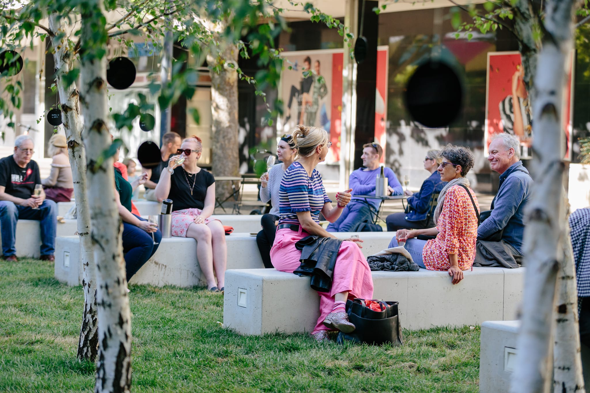 People sit and enjoy drinks along City Walk in the afternoon.