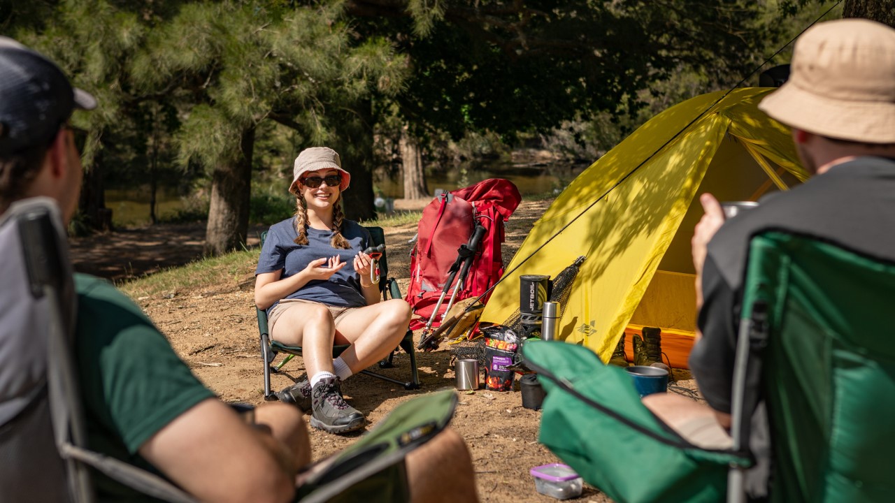 People sitting in chairs at the Cotter Campground just a 25 minute drive from the city 