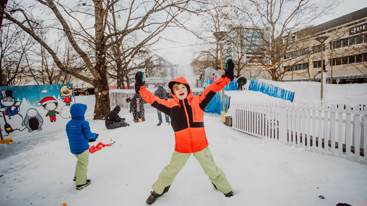 A young child enjoying the snow play at Winter in the City