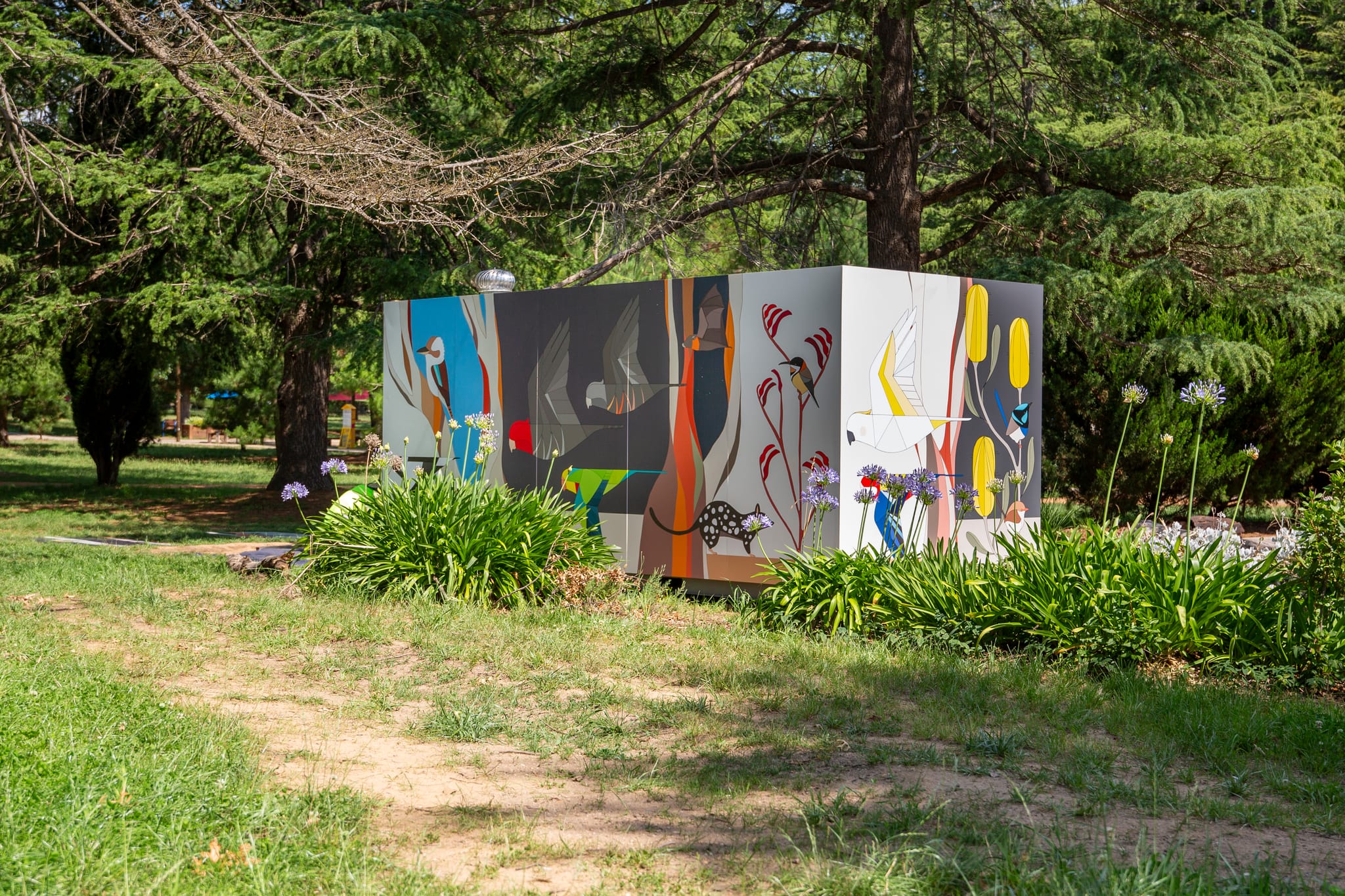 A storage container in Haig Park featuring artwork containing native species created by Eggpicnic