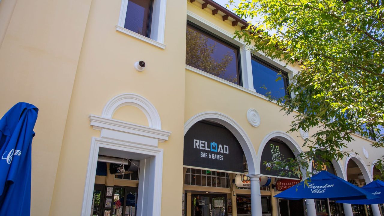 Freshly painted façade with 'Reload' signage in archway. 
