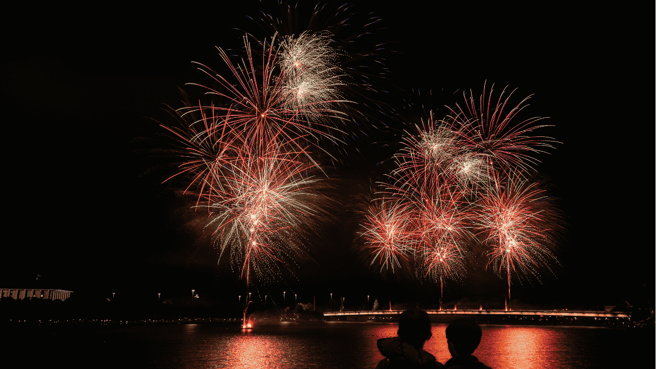 Red coloured fireworks in the night sky.