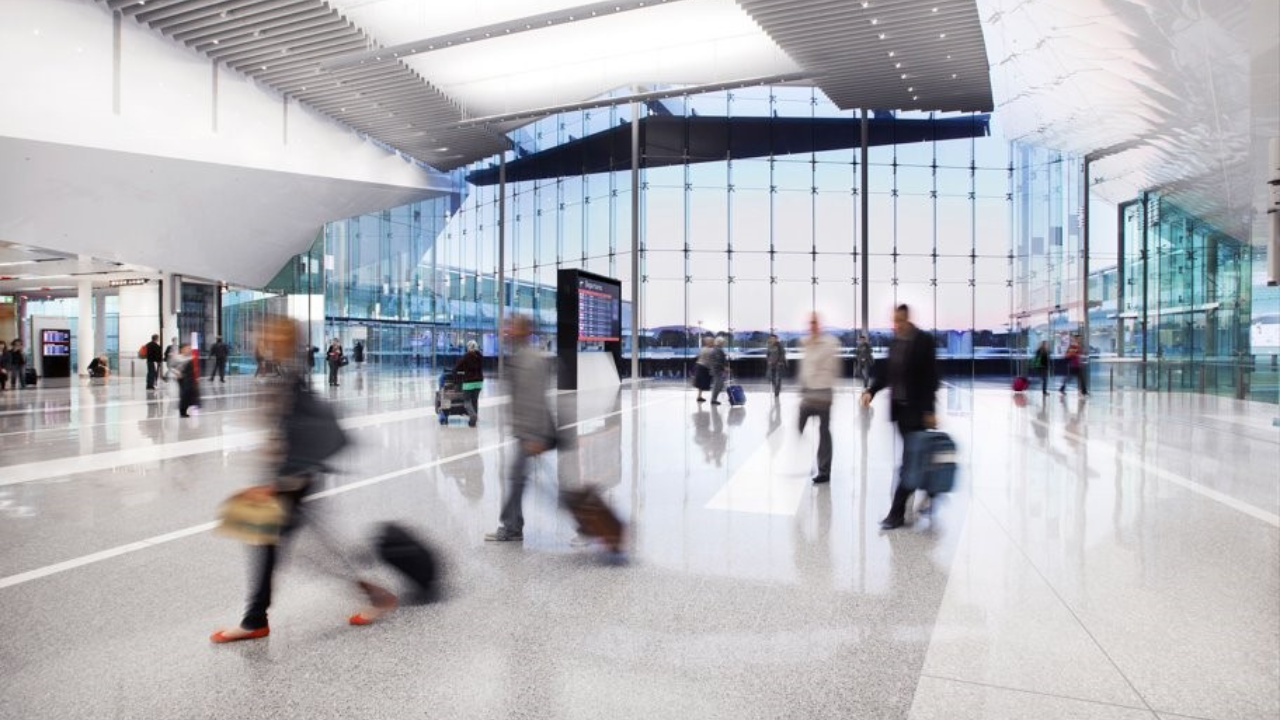 People walking through an open space within Canberra Airport.