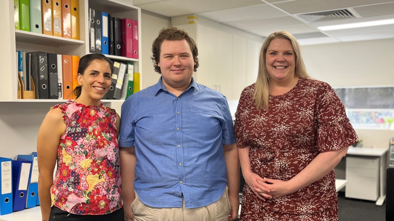 Veronique, Jesse, Amy standing in office representing Bridge to Brighter Futures Program