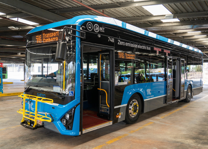 A bus parked at a depot. 